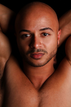 Bald ebony muscle man Simon strokes dick and shoots a load