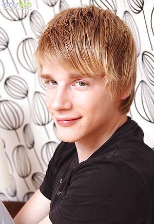 Twink Chris Powers tugs on his hard uncut cock. by BoyFun image 1